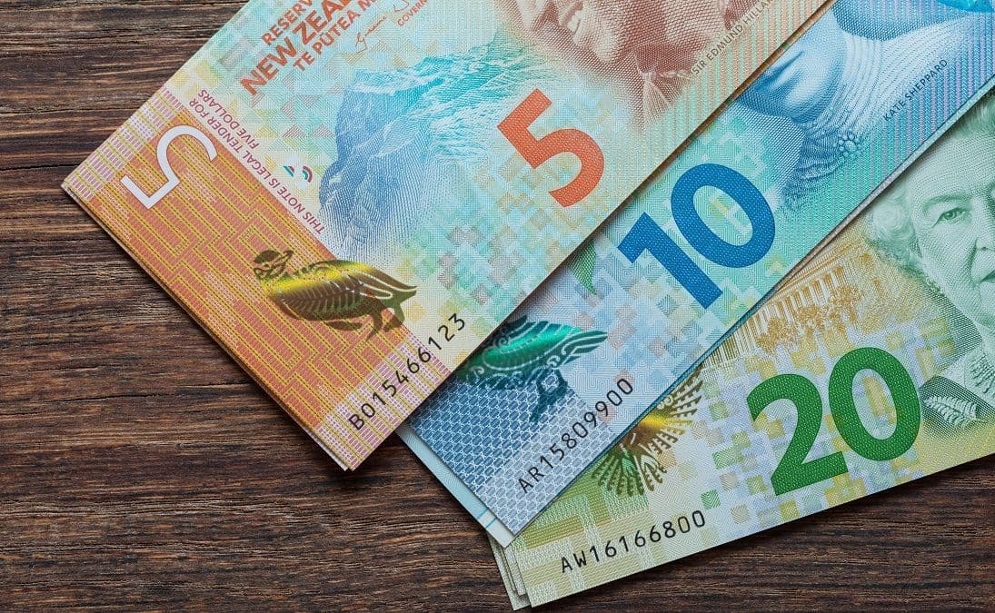 New Zealand give, ten and twenty doller notes on a wood surface