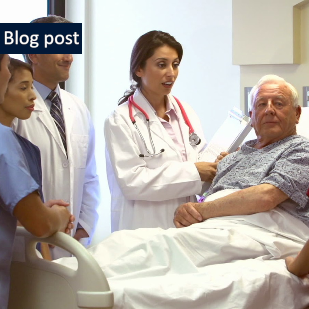 doctors and nurses talk as they stand around a man in a hospital bed